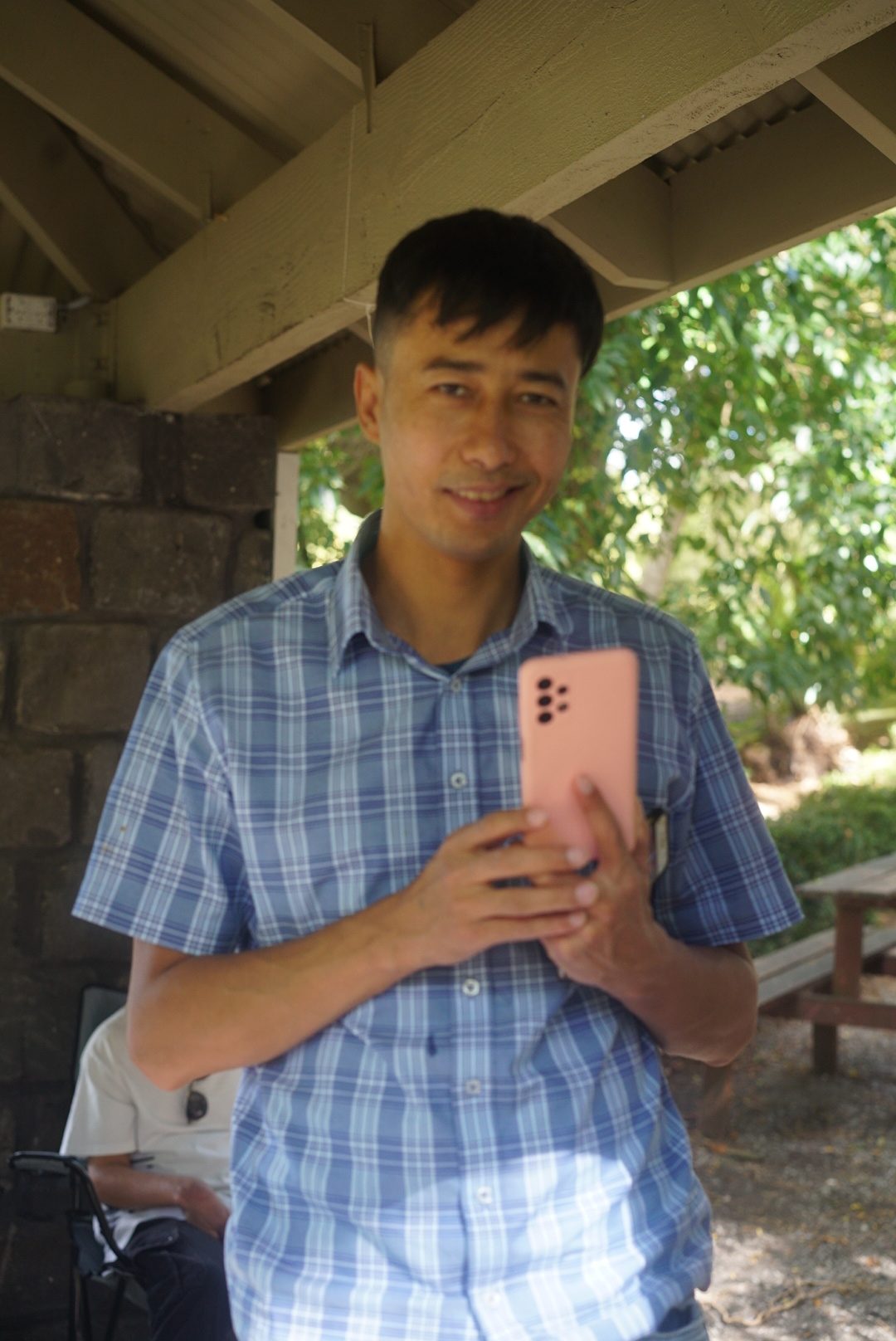The Image Is Showing a Man Holding Smartphone.